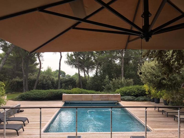 Photographie d'une piscine à débordement. Vue de la terasse. Planète Eau Piscines, Construction, Rénovation, Entretien. Artisan pisciniste sur Aix en Provence et ses alentours.